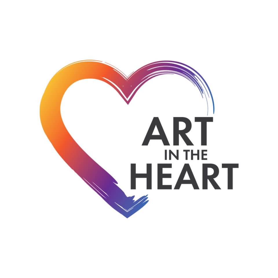 Logo of 'Art in the Heart', featuring a colorful heart design with vibrant gradient colors and the text 'ART IN THE HEART' in bold.